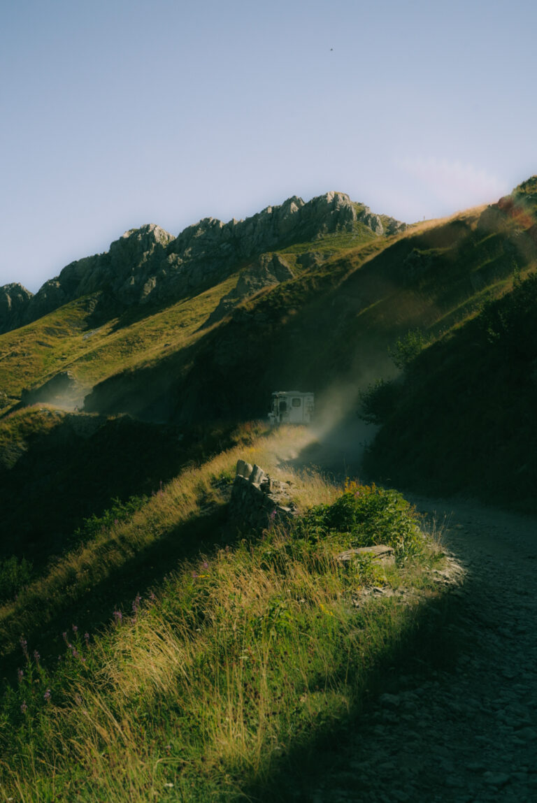 Suzuki Jimny driving the Salt Road Italy 4x4 with mountain views and bikers on the trail