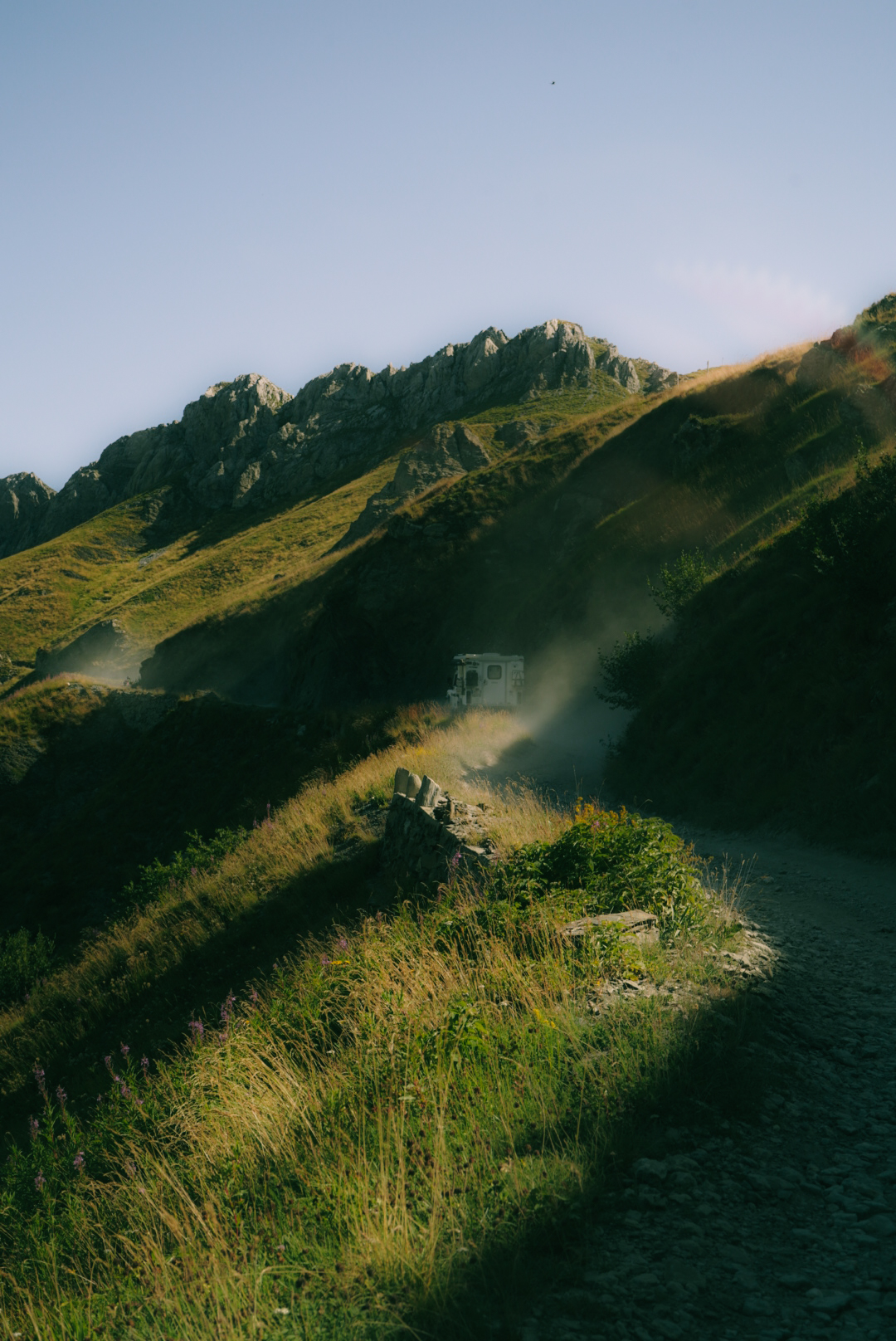 Suzuki Jimny driving the Salt Road Italy 4x4 with mountain views and bikers on the trail