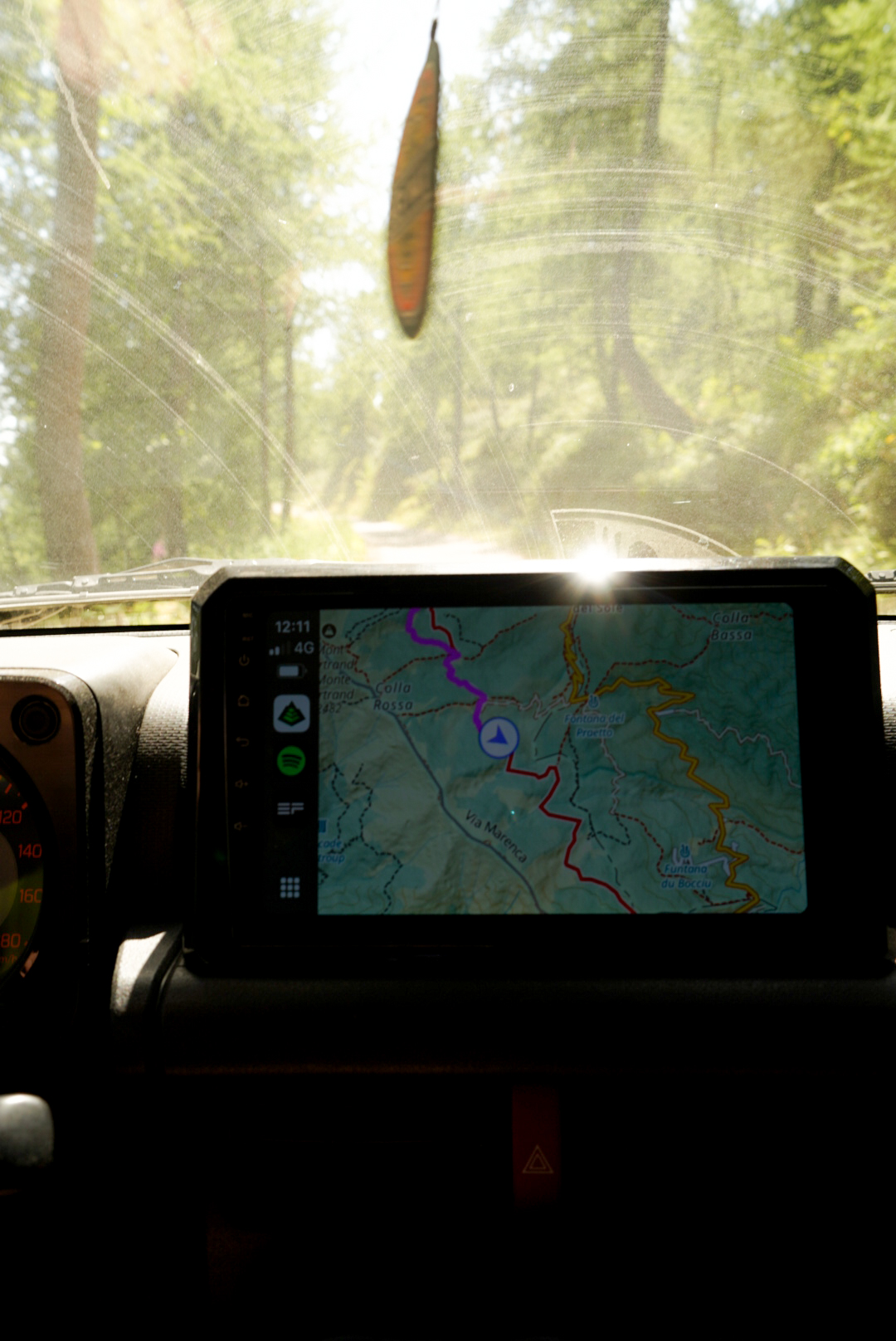 Suzuki Jimny driving the Salt Road Italy 4x4 with mountain views and bikers on the trail