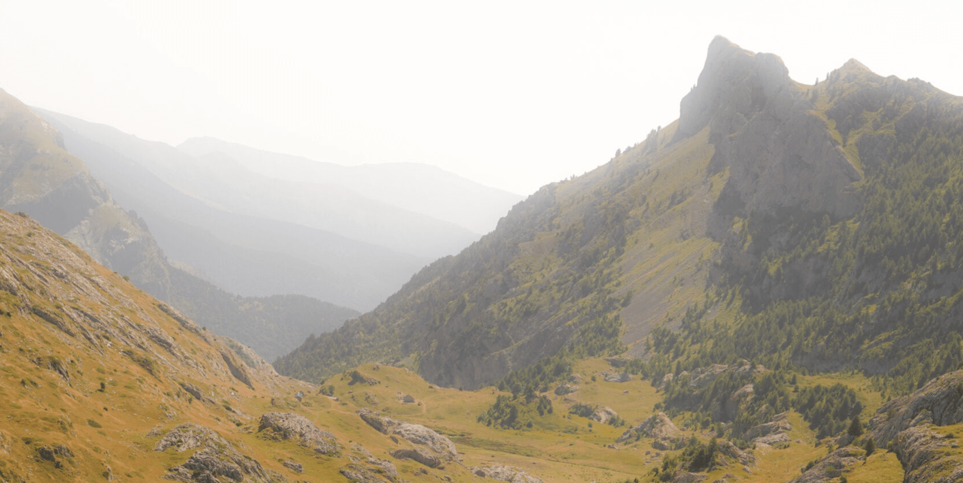 Suzuki Jimny driving the Salt Road Italy 4x4 with mountain views and bikers on the trail